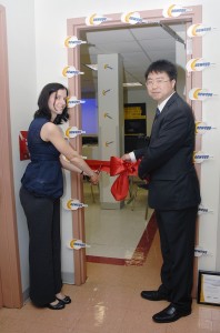 Ms. Deak and Newegg's Kevin Lee cut the ribbon